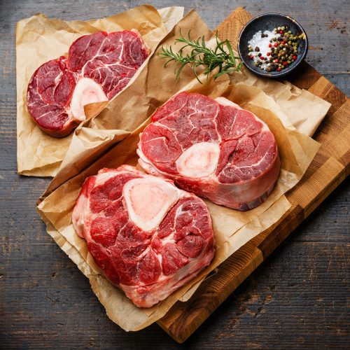 raw-fresh-cross-cut-veal-shank-and-seasonings-for-making-osso-buco-on-wooden-cutting-board.jpg